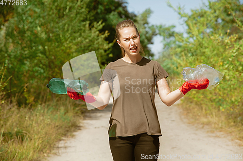 Image of Volunteer tidying up rubbish on beach