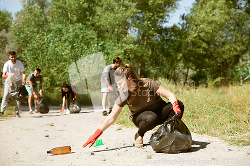 Image of Group of volunteers tidying up rubbish on beach