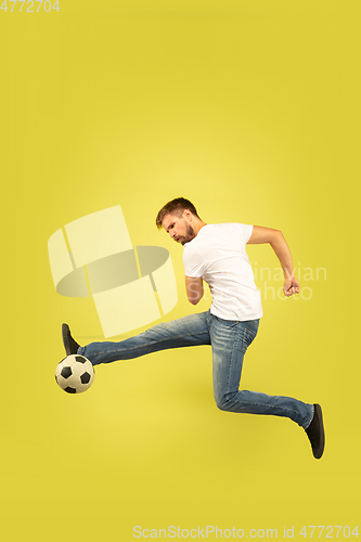 Image of Full length portrait of happy jumping man on yellow background