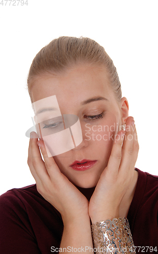 Image of Sad looking woman with hand on face