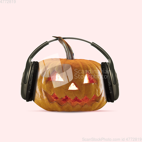 Image of Scary pumpkin on coral background, the night of fear