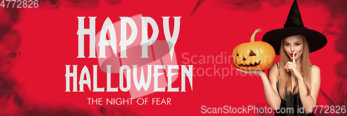 Image of Young woman in hat as a witch on scary red background