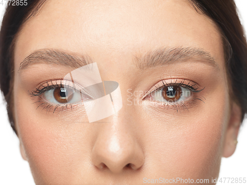 Image of Close up shot of well-kept female big eyes and cheeks on white studio background