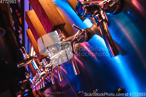 Image of Beer pouring machine in modern neon lights