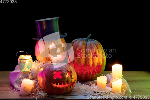 Image of Halloween pumpkin head jack lantern with scary evil faces and candles
