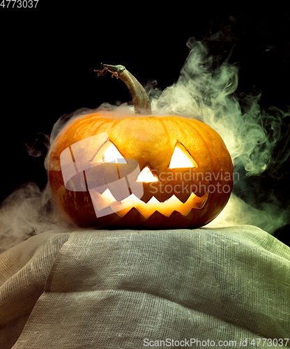 Image of Halloween pumpkin head jack lantern with scary evil face