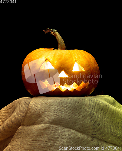 Image of Halloween pumpkin head jack lantern with scary evil face