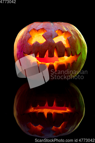 Image of Halloween pumpkin head jack lantern with scary evil face