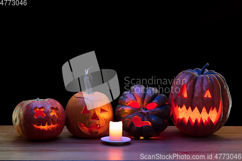 Image of Halloween pumpkin head jack lantern with scary evil faces and candles