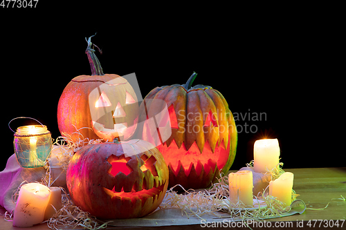 Image of Halloween pumpkin head jack lantern with scary evil faces and candles