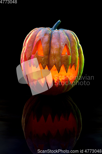 Image of Halloween pumpkin head jack lantern with scary evil face