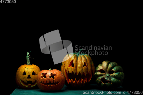 Image of Halloween pumpkin head jack lantern with scary evil faces