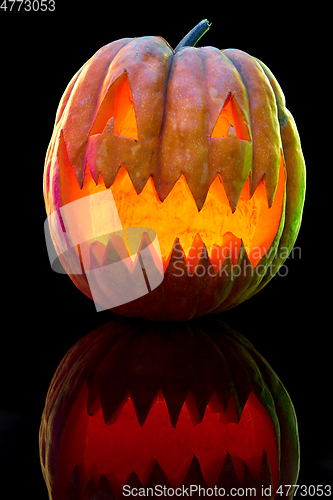 Image of Halloween pumpkin head jack lantern with scary evil face