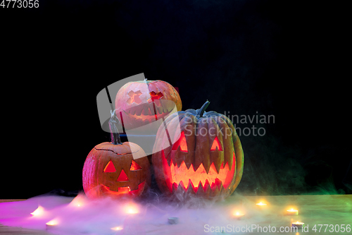 Image of Halloween pumpkin head jack lantern with scary evil faces