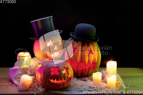 Image of Halloween pumpkin head jack lantern with scary evil faces and candles