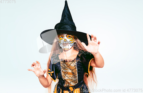 Image of Little girl like a witch on white background