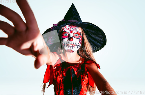 Image of Little girl like a witch on white background