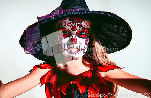 Image of Little girl like a witch on white background