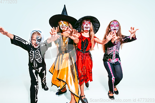 Image of Kids or teens like witches and vampires on white background