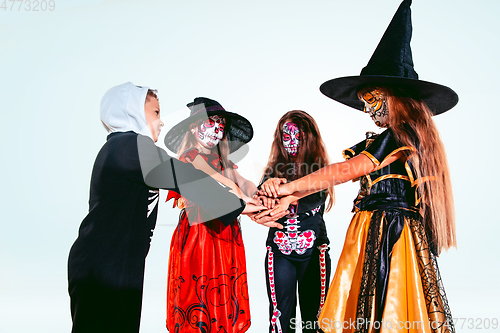 Image of Kids or teens like witches and vampires on white background