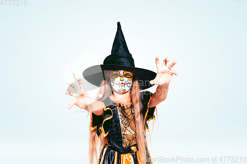 Image of Little girl like a witch on white background