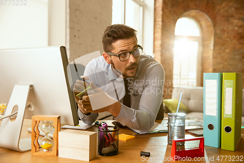 Image of A young businessman moving in office, getting new work place