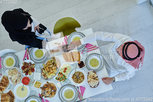 Image of Muslim couple sharing dates for starting iftar top view