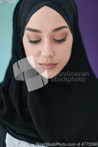 Image of Portrait of Arab woman in traditional clothes using mobile phone.