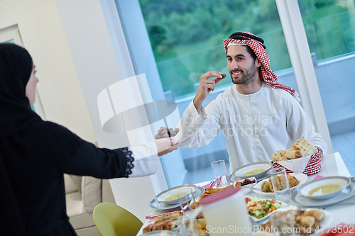 Image of Muslim couple sharing dates for starting iftar