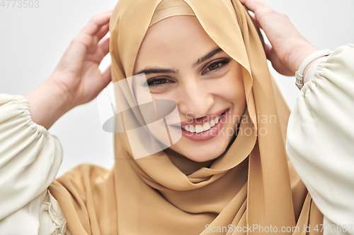 Image of Portrait of young muslim woman wearing hijab on isolated white background