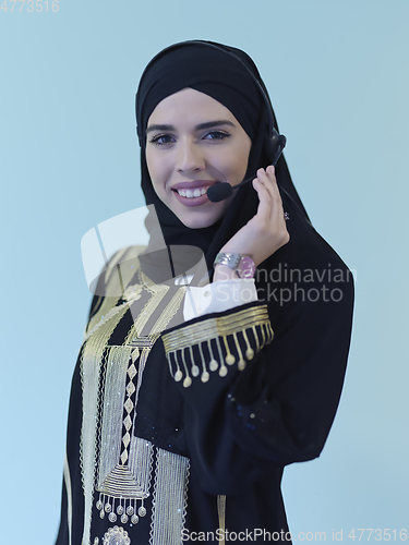 Image of Portrait of young muslim woman with headphones