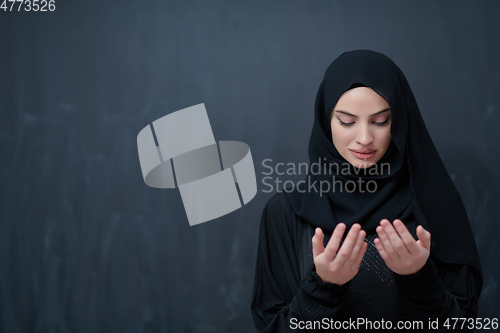 Image of Portrait of young Muslim woman making dua