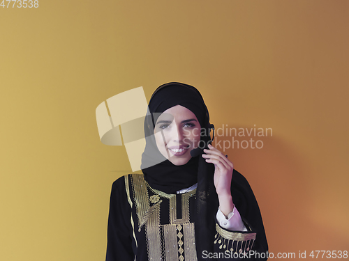 Image of Portrait of young muslim woman with headphones