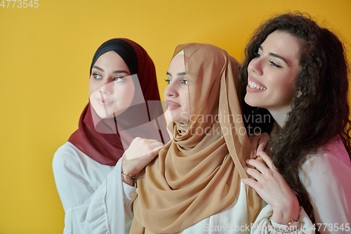 Image of Young muslim women posing on yellow background