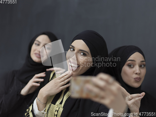 Image of Portrait of Arab women wearing traditional clothes or abaya taking selfie