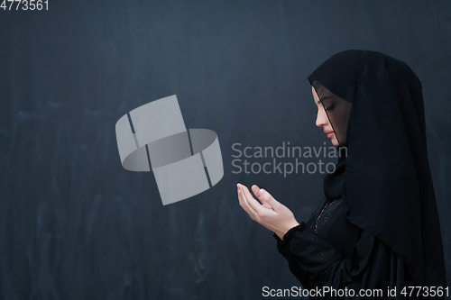 Image of Portrait of young Muslim woman making dua