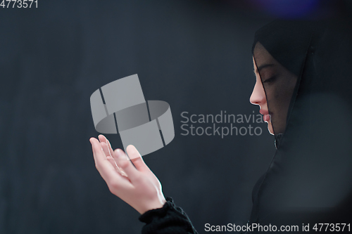 Image of Portrait of young Muslim woman making dua