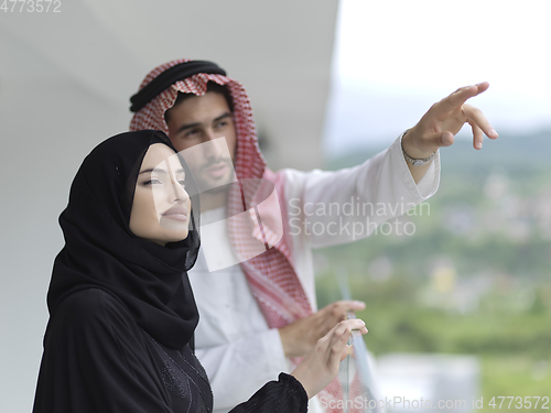 Image of Portrait of young muslim couple on balcony