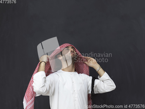 Image of Portrait of young muslim man wearing traditional clothes