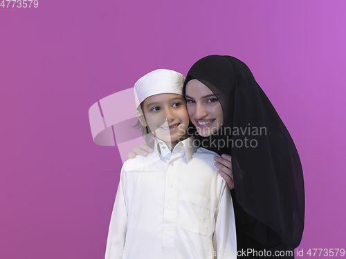 Image of young arabian mother and son wearing traditional clothes