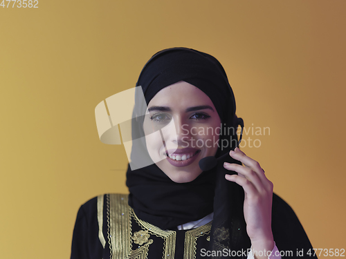 Image of Portrait of young muslim woman with headphones