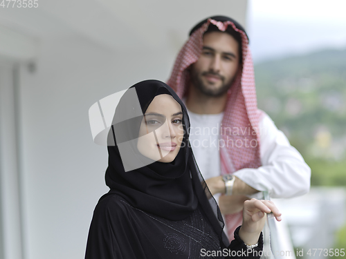 Image of Portrait of young muslim couple on balcony