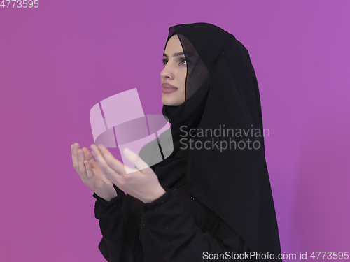 Image of Portrait of young Muslim woman making dua