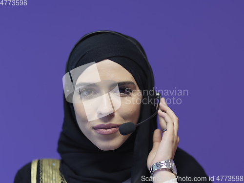 Image of Portrait of young muslim woman with headphones