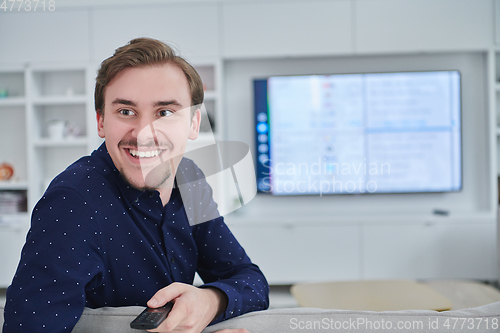 Image of Happy young muslim man in modern home