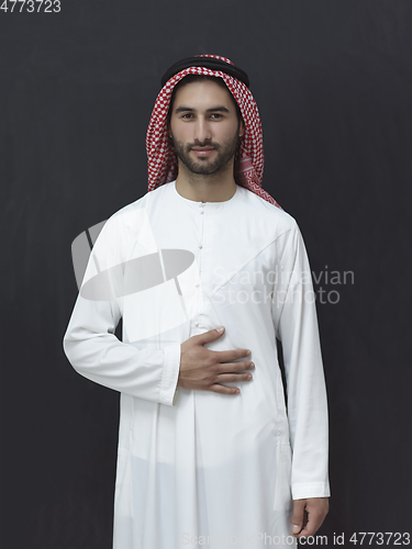 Image of Portrait of young muslim man wearing traditional clothes