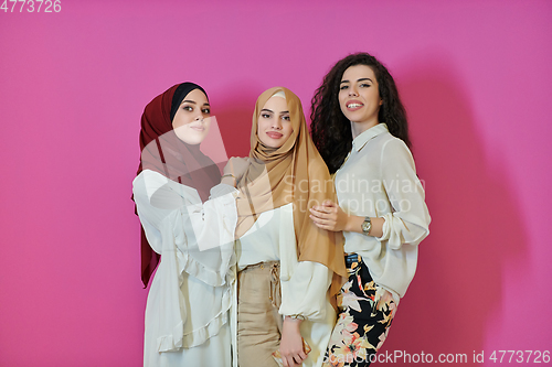 Image of Young muslim women posing on pink background