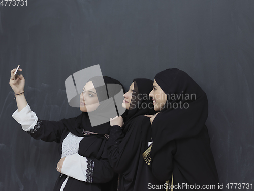 Image of Portrait of Arab women wearing traditional clothes or abaya taking selfie