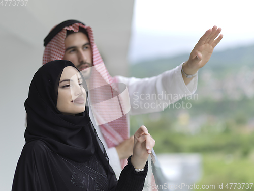 Image of Portrait of young muslim couple on balcony