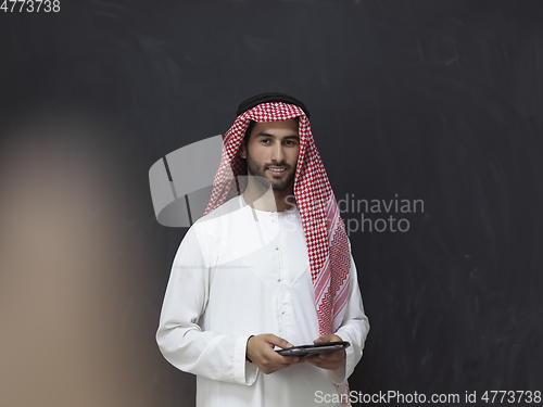 Image of Portrait of young muslim businessman using tablet